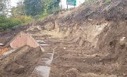 Construction of the retaining wall on Dame Dorothy Street to facilitate future road widening. Sheet piles are being pushed 13 metres into the ground to support the widened road.