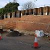 Construction of the retaining wall on Dame Dorothy Street to facilitate future road widening. Sheet piles are being pushed 13 metres into the ground to support the widened road.
