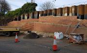 Construction of the retaining wall on Dame Dorothy Street to facilitate future road widening. Sheet piles are being pushed 13 metres into the ground to support the widened road.